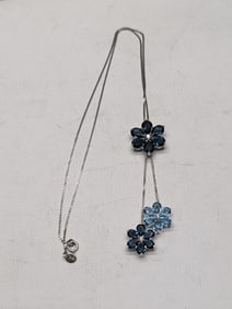 18 inch sterling chain with three blue and white crystal flower petal pendants.