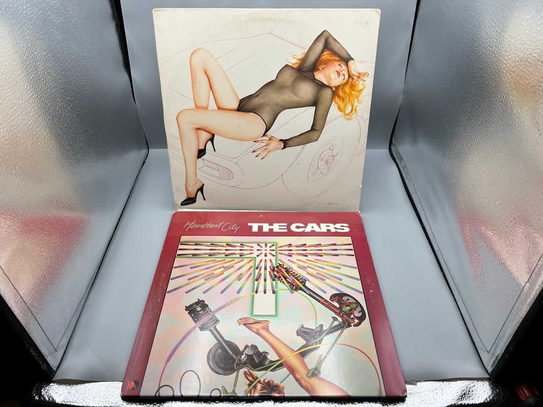The Cars (2 LP Lot): Candy-O (1979), Alberto Vargas cover art, promo notch in cover; and Heartbeat: The Cars (2 LP Lot): Candy-O (1979), Alberto Vargas cover art, promo notch in cover; and Heartbeat City (1984), gatefold - Records have not been tested by the auction house for play quality. All items