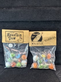 Whistle and Mountain Dew;  Marbles in sealed Bags
