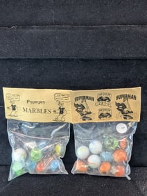Popeyes and Superman;  Marbles in sealed Bags