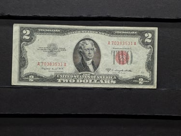 1953 B Red Seal 2 Dollar Bill with good corners and no writing in protective plastic sleeve.