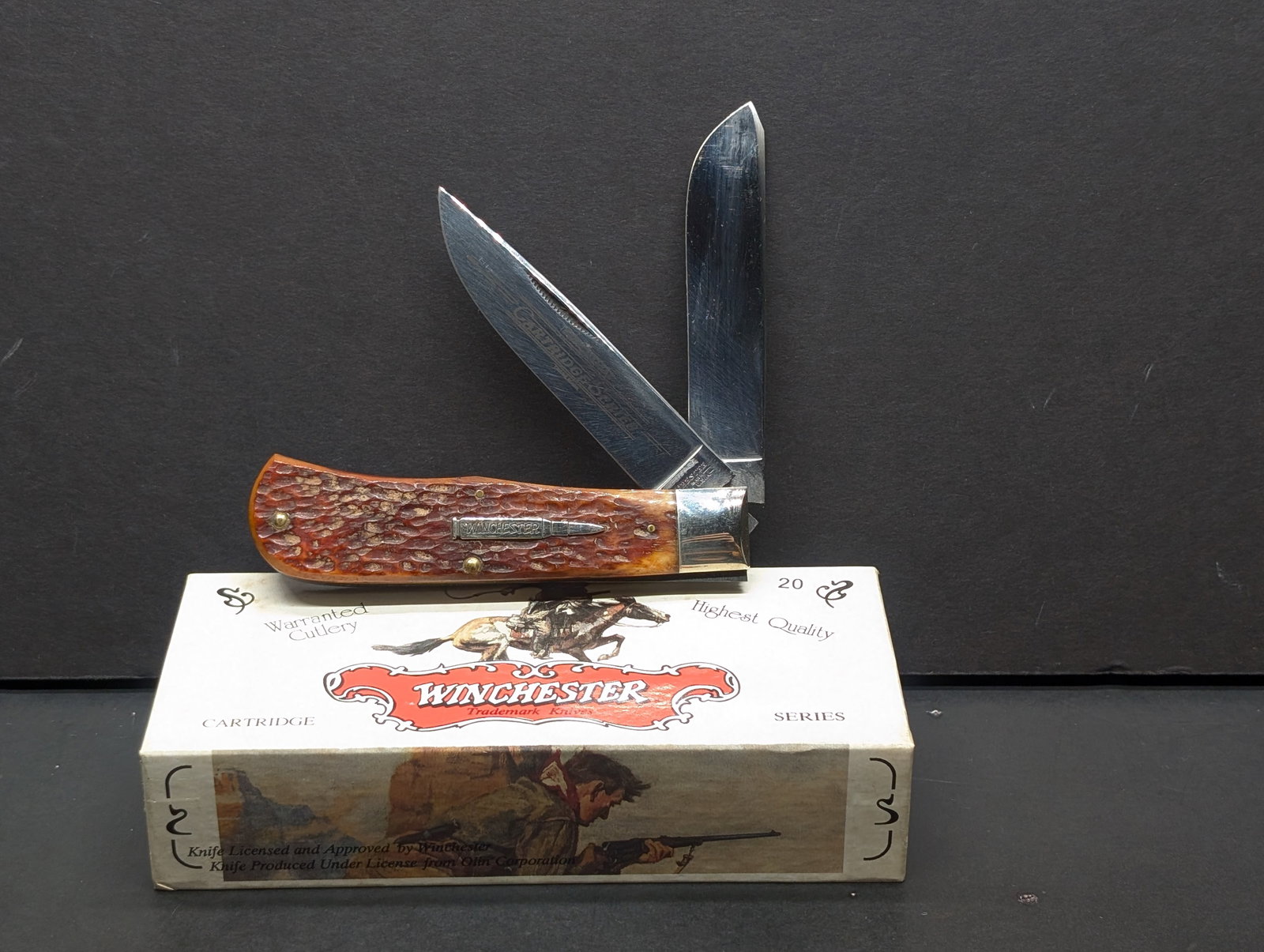 Winchester Cartridge Series USA 1996, W18 29103 Large Trapper Burnt Orange Bone Knife w/Box Made In: USA made Winchester Trade Mark jack/folding hunter (approx 4½ closed) from the Cartridge Series: peach seed jigged bone handles with nickel silver bolster & shield, brass pins/liners; sabre gro