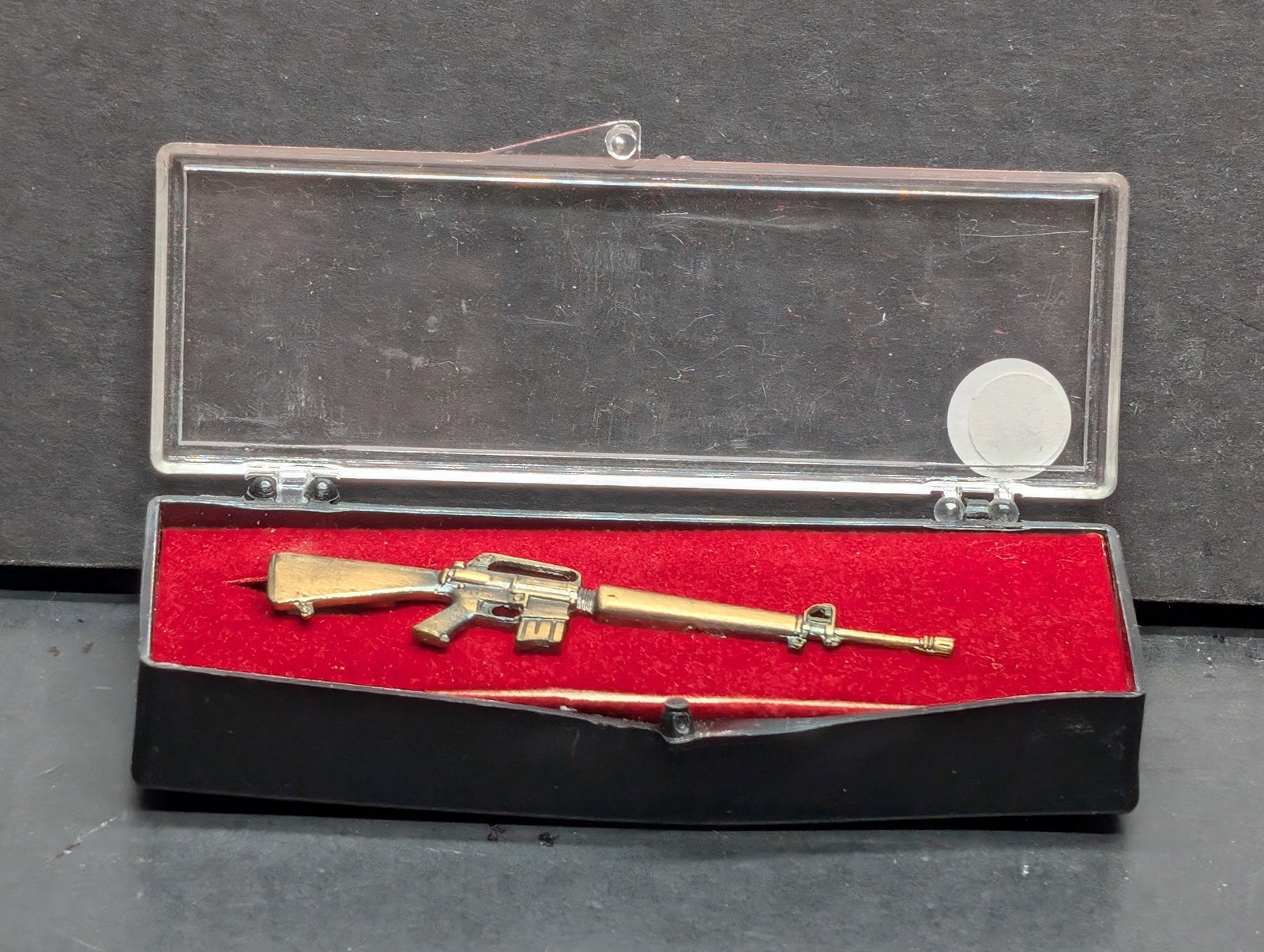 Rifle Tie Clip NIB Vintage: Vintage brass M16 rifle tie clip, Special Edition military design. Blade length not applicable. Solid brass construction with detailed craftsmanship. Condition shows minor wear, adding to its authenti