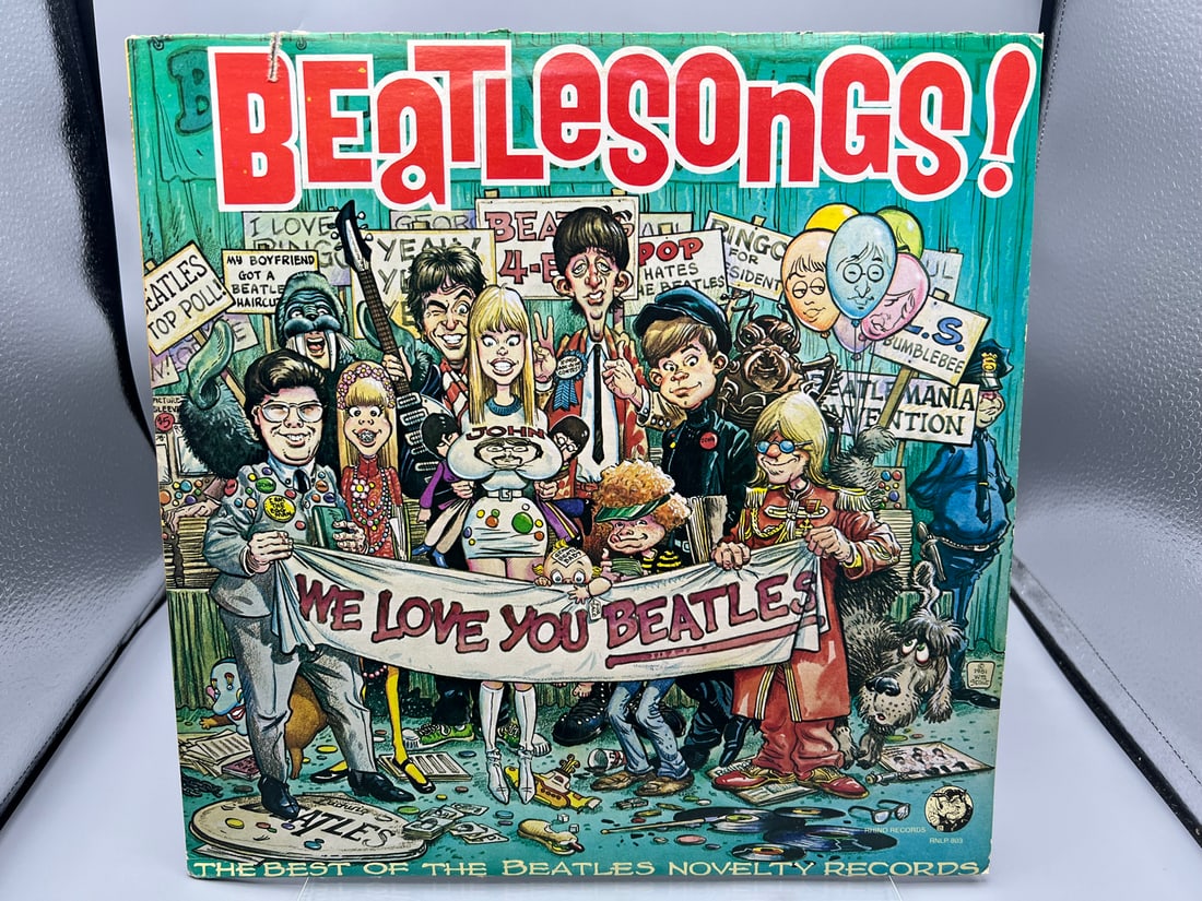 Beatlesongs! (1982), compilation of novelty songs/parodies of Beatle music. This original,: Beatlesongs! (1982), compilation of novelty songs/parodies of Beatle music. This original, controversial cover (by underground comic artist William Stout) features caricature of M.D. Chapman, John Len