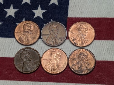 Six (6) Lincoln Pennies, various errors - "woodies," 1983 die chip date, printed thru errors etc.