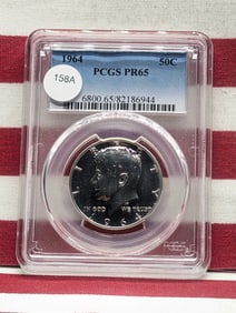 1964 Kennedy Half Dollar. Slabbed by PCGS, top grader, as Proof 65. Bright white coin.