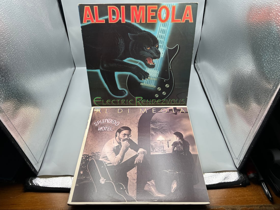 Al Di Meola (2 LP Lot): Electric Rendevouz (1982), promo stamp on back cover; and Splendido Hotel (1 of 7)