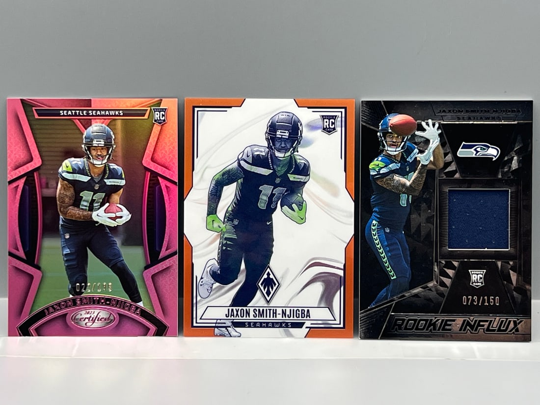 Lot of (3) Jaxon Smith-Njigba Football Serial Numbered Rookie Cards - 1 Relic (1 of 2)
