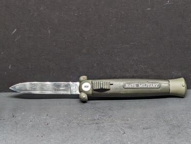 A NATO Military switchblade knife with a green handles, Nato Military Blade Assisted Knife Vintage
