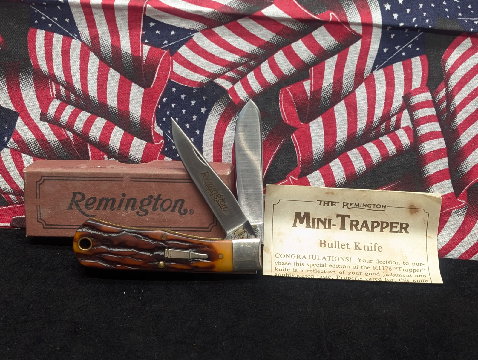 1991 Remington Mini-Trapper Bullet Knife, R1178, two-blade trapper pattern,: amber jigged bone handles with inlaid bullet shield, tang stamped Remington UMC, includes original Remington box and paperwork