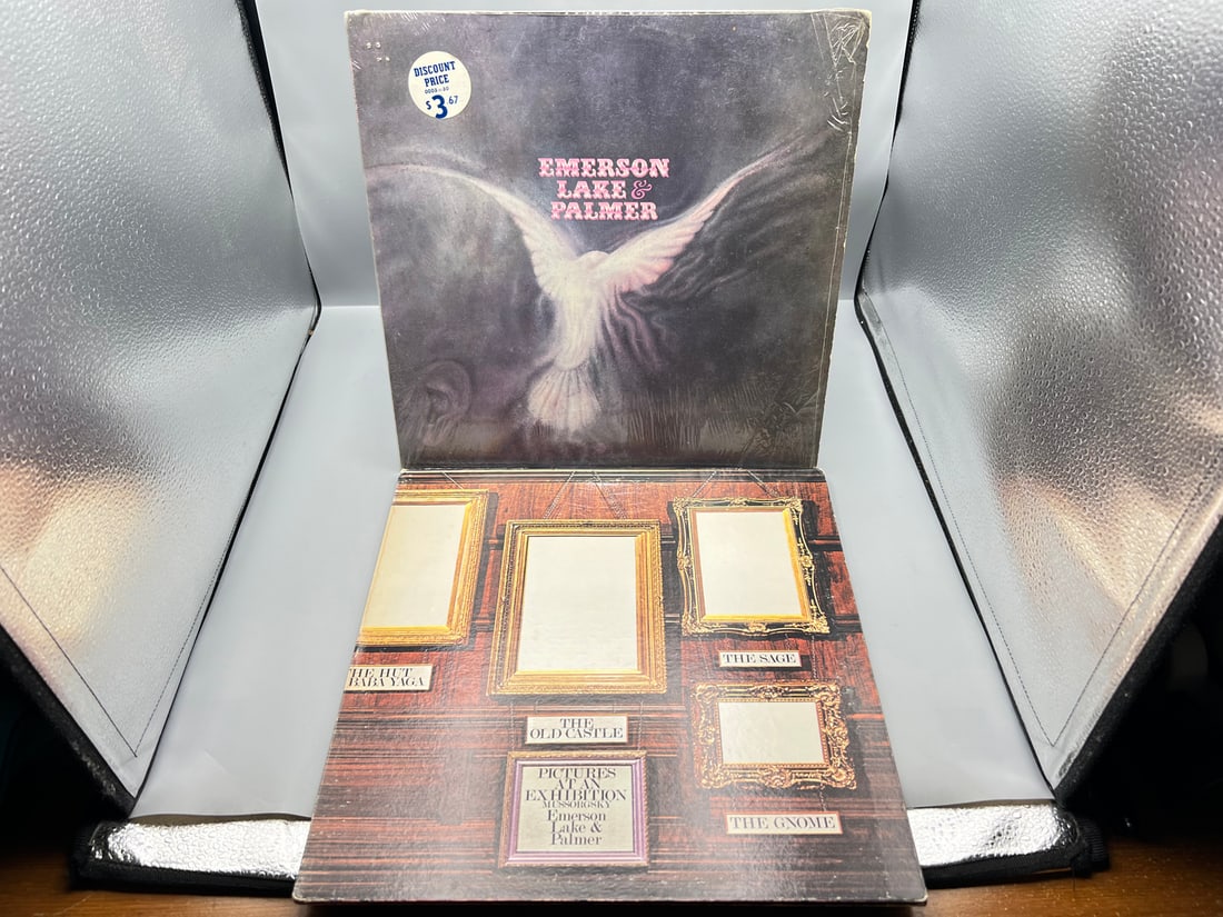 Emerson, Lake & Palmer (2 LP Lot): Self-titled (1971), in original shrinkwrap with price sticker;: Emerson, Lake & Palmer (2 LP Lot): Self-titled (1971), in original shrinkwrap with price sticker; and Pictures At An Exhibition (1977), gatefold - Records are untested by auction house for play qualit