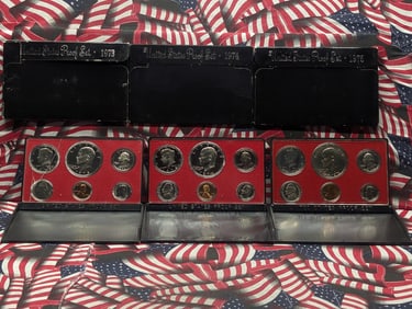 1973-S, 1974-S & 1975-S U.S. Mint Proof Sets in OGP. The 1973-S set has a cracked case.