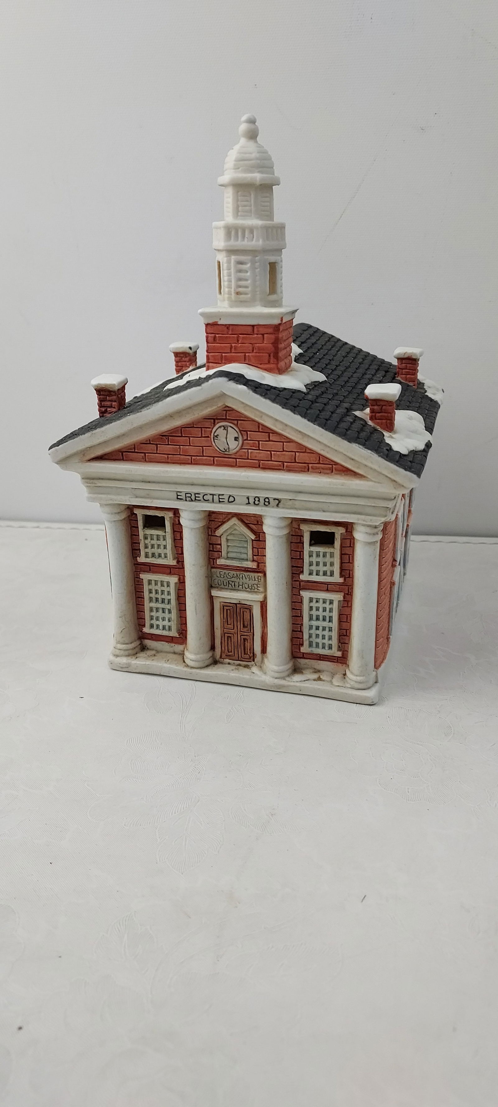 1991 Flambro Pleasantville 1893 Storybook Village Court House: This miniature architectural figurine is identified as the "Pleasantville 1893" "Court House" from the Storybook Village collection, designed exclusively for Flambro in 1991 by Joan Dara Victor. The p