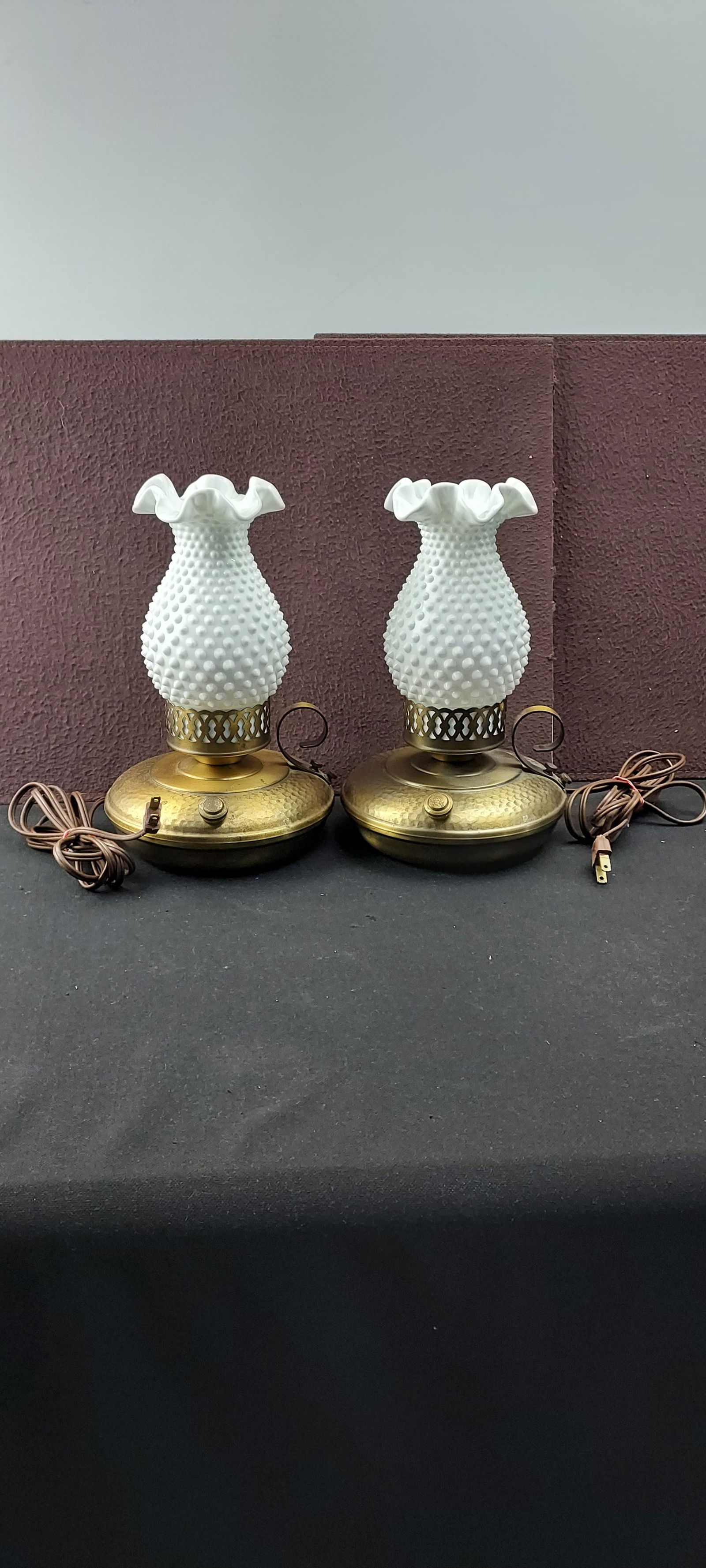 Vintage Mid-Century Pair of Hobnail Milk Glass Hurricane Table Lamps, General Electric Sockets: A vintage Mid-Century pair of electric table lamps, commonly referred to as boudoir or hurricane lamps, featuring white hobnail milk glass shades. Each lamp is constructed with a distinctive white mil