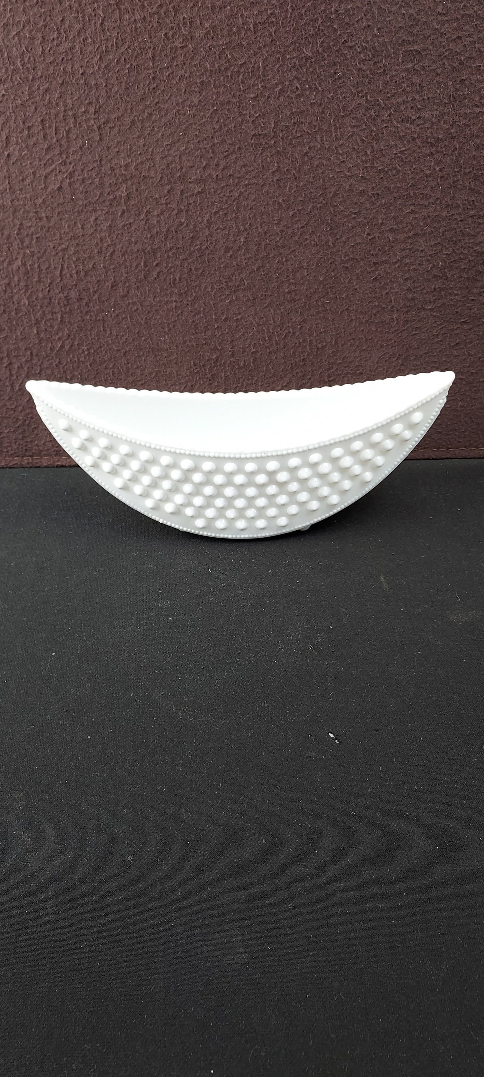 Fenton Milk Glass Hobnail 10" Crescent Planter Dish: This decorative boat-shaped dish is crafted from classic white milk glass, featuring a distinctive hobnail texture covering its exterior surface. The interior remains smooth, contrasting with the text