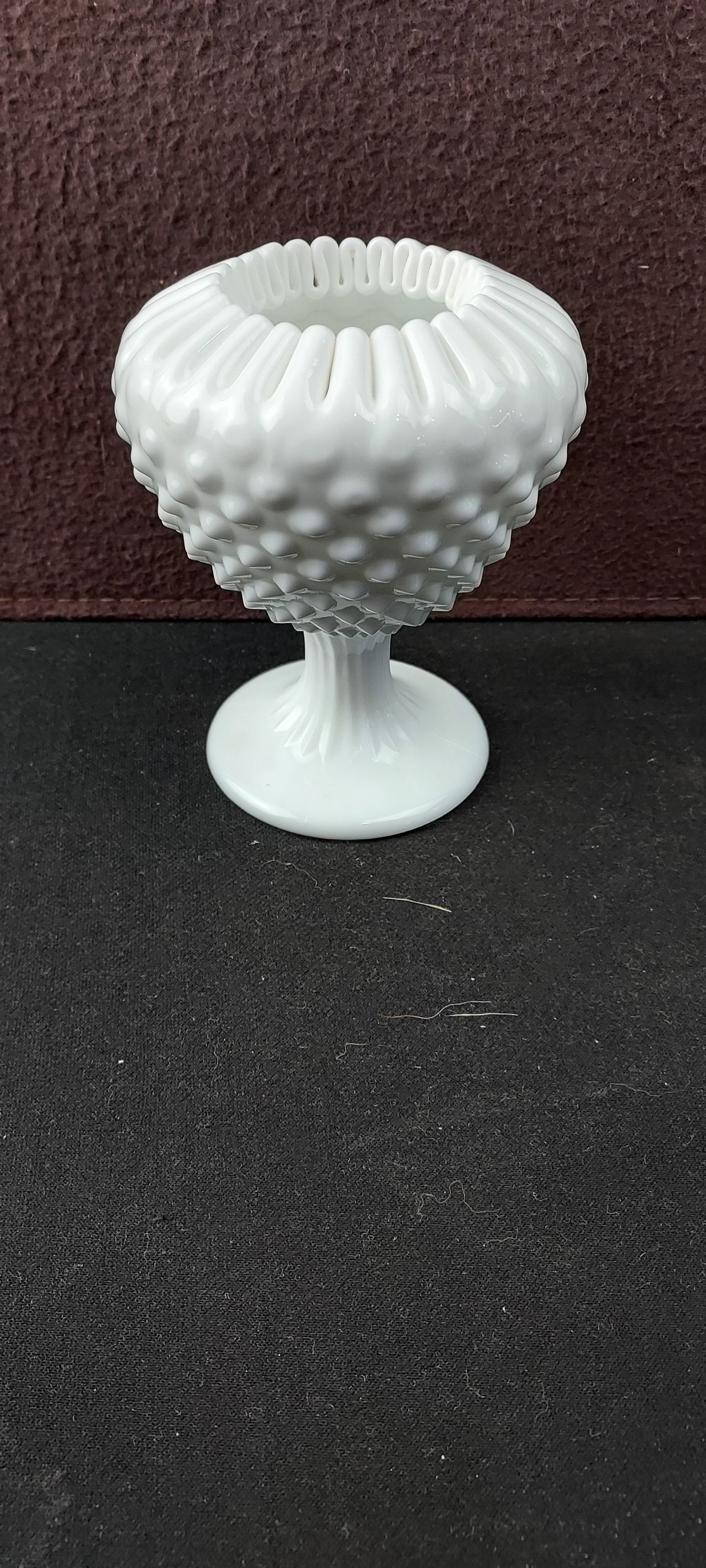 Fenton Hobnail Milk Glass Footed Ivy Vase Compote with Crimped Rim: A classic example of Fenton Art Glass, this opaque white milk glass piece is identified as a Hobnail Footed Ivy Vase or Compote. It features a prominent hobnail texture across the bowl, a distinct ruf
