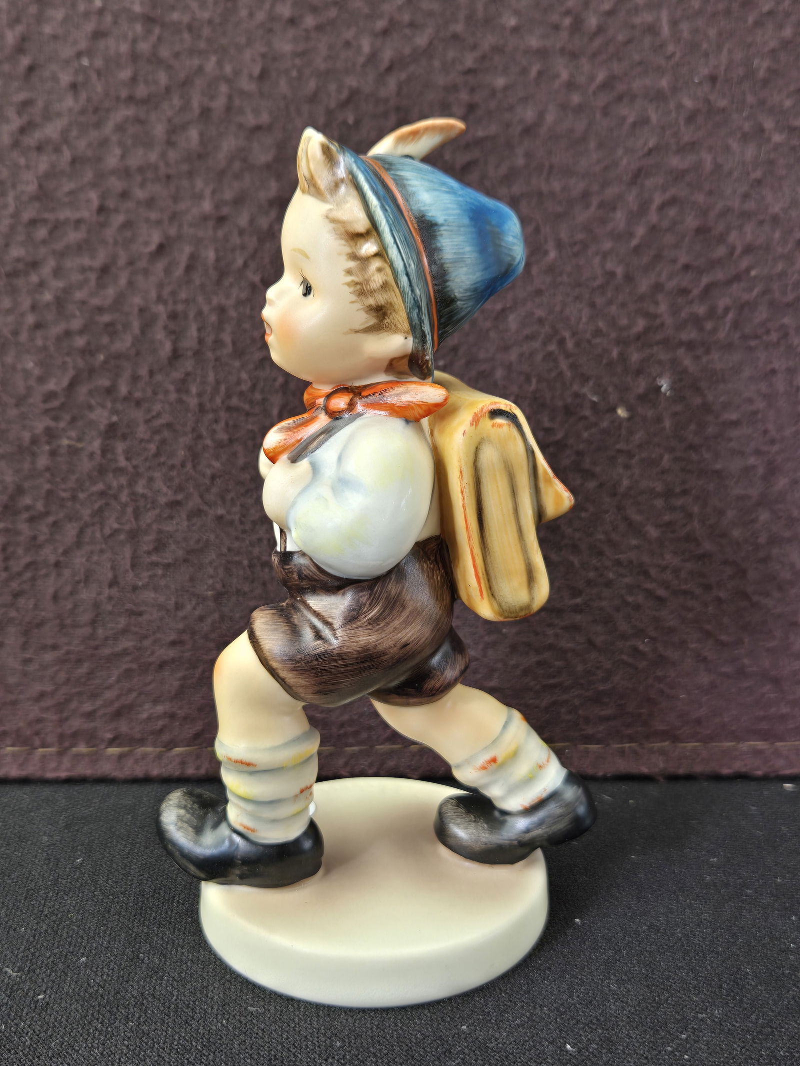 Goebel Hummel Germany 'Schulschw?nzer School Boy' Figurine #82/0: A vintage Goebel Hummel Germany ceramic figurine, titled 'Schulschw?nzer School Boy,' catalog number 82/0 (often referred to as 82 2/0, indicating a size variation). The hand-painted figurine depicts