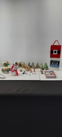 A Collection of Assorted Christmas Decorations, Village Houses, Snow Globes, Sealed Cards & Brass