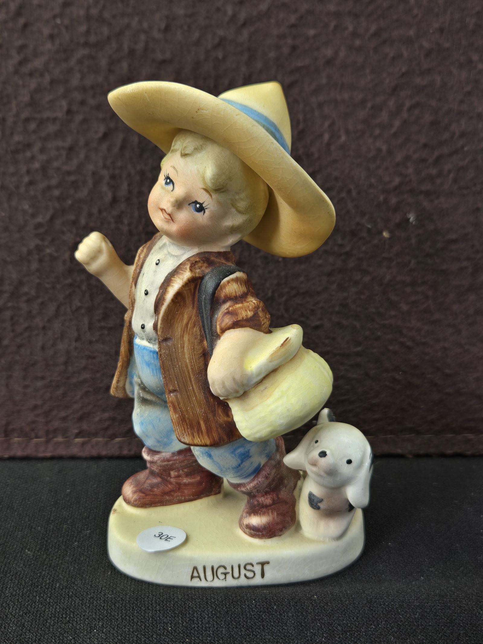 Vintage Lefton 'August' Boy with Dog Ceramic Figurine #2366: This vintage hand-painted ceramic figurine, model number 2366, is from Lefton's 'Months of the Year' series, produced as 'Exclusive Japan'. The figurine depicts a young boy in a wide-brimmed straw hat