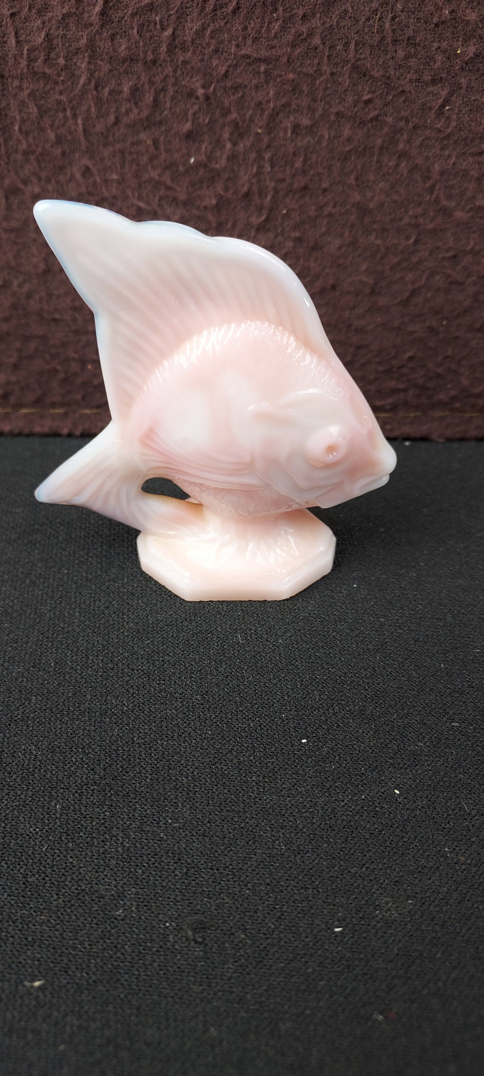 Fenton Rosalene Sunfish Figurine: A vintage Fenton Rosalene Sunfish Figurine, crafted from opalescent milk glass. This decorative art glass piece features a translucent pink or peach hue that transitions to a more opaque white in thic