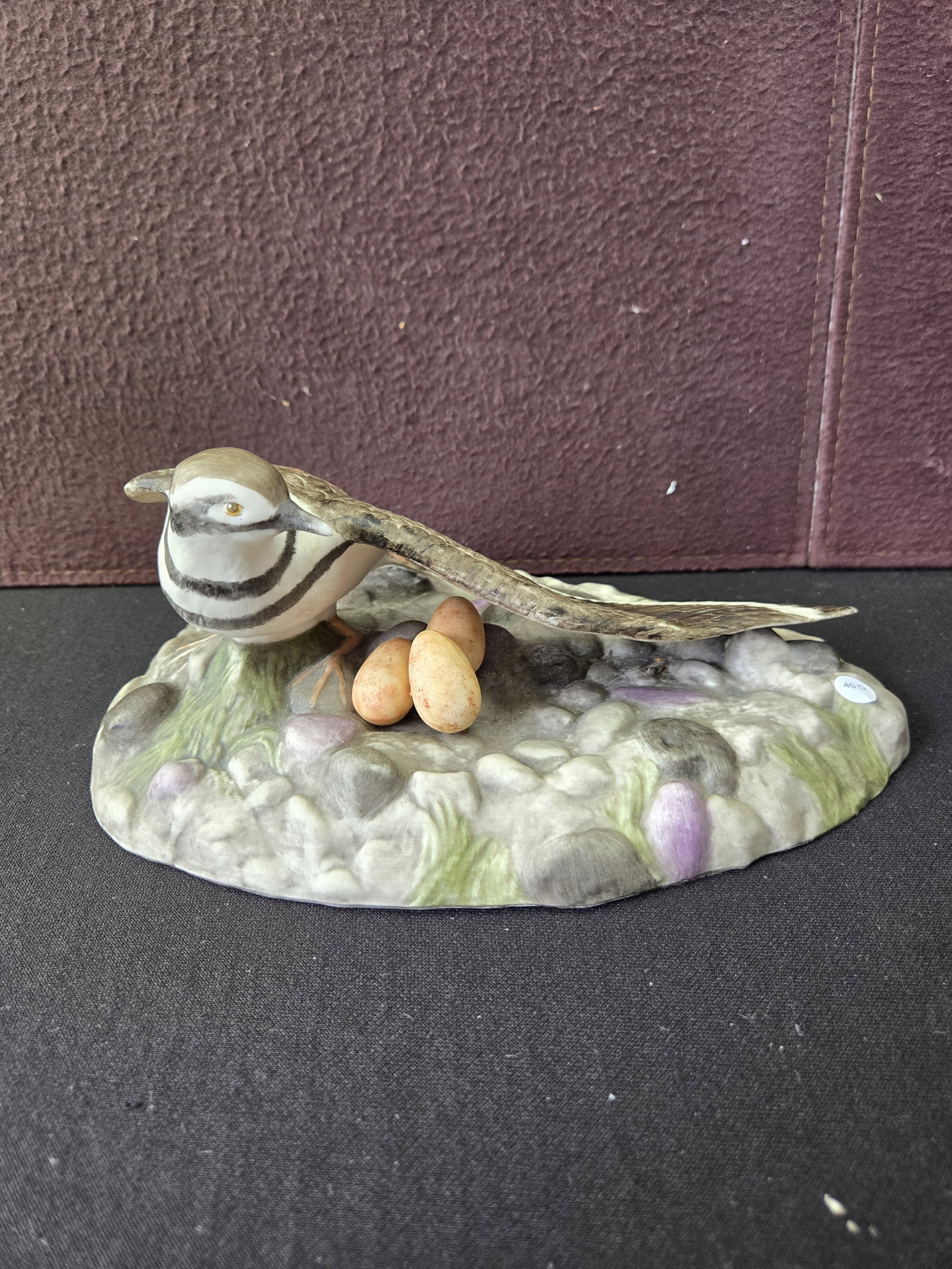 Boehm Killdeer Porcelain Figurine, U.S.A.: A Boehm porcelain figurine depicting a Killdeer bird. The figurine features a Killdeer with distinct black and white neck bands and brown plumage accented with reddish-brown, resting protectively over