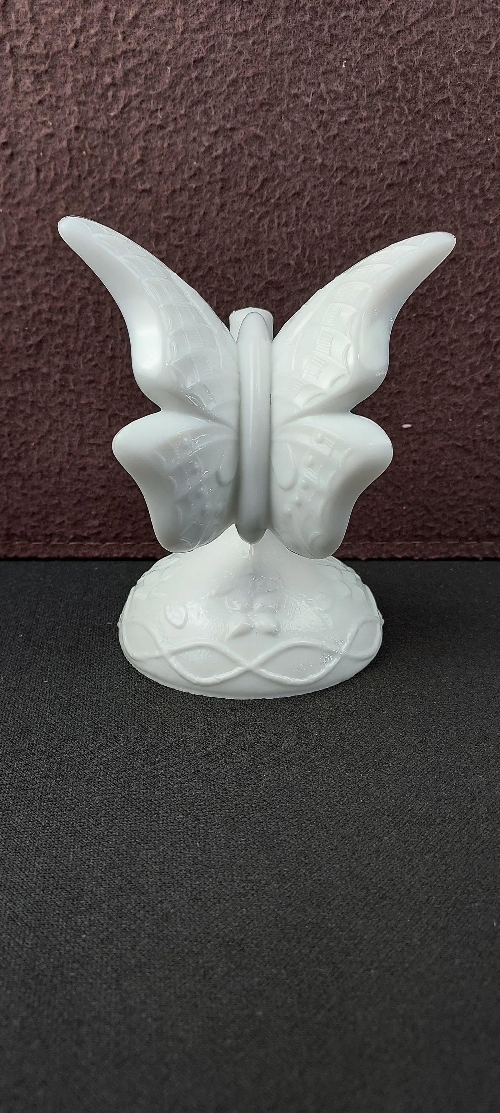 Fenton Art Glass White Opalescent Butterfly on Stand: This exquisite Fenton Art Glass White Opalescent Butterfly on Branch features a delicate butterfly with subtle raised detailing on its wings and body, gracefully perched atop a pedestal-like base. The