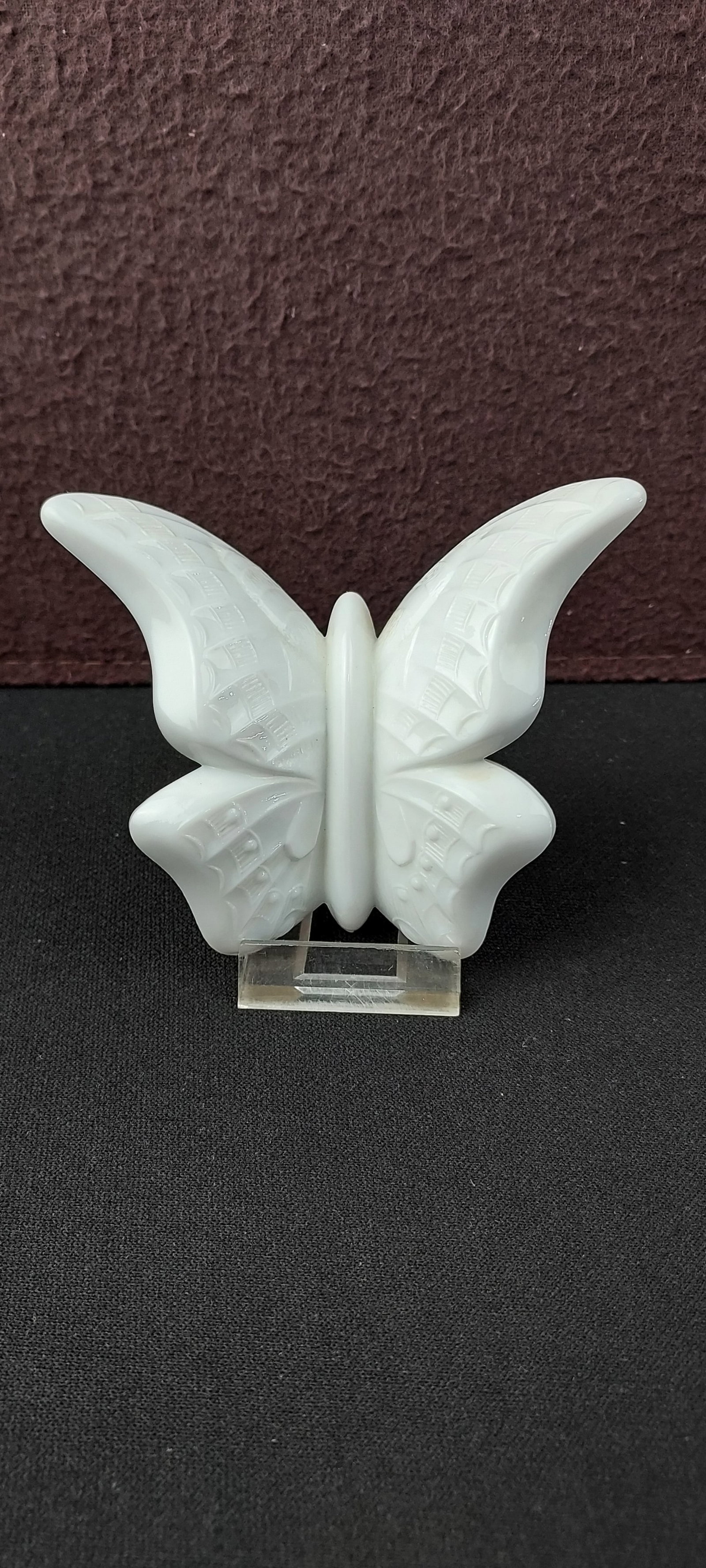 Fenton White Crystal Velvet Butterfly Figurine: An exquisite Fenton white Crystal Velvet glass butterfly figurine. This opaque white decorative piece features finely textured wing patterns, characteristic of Fenton's renowned craftsmanship. The rev