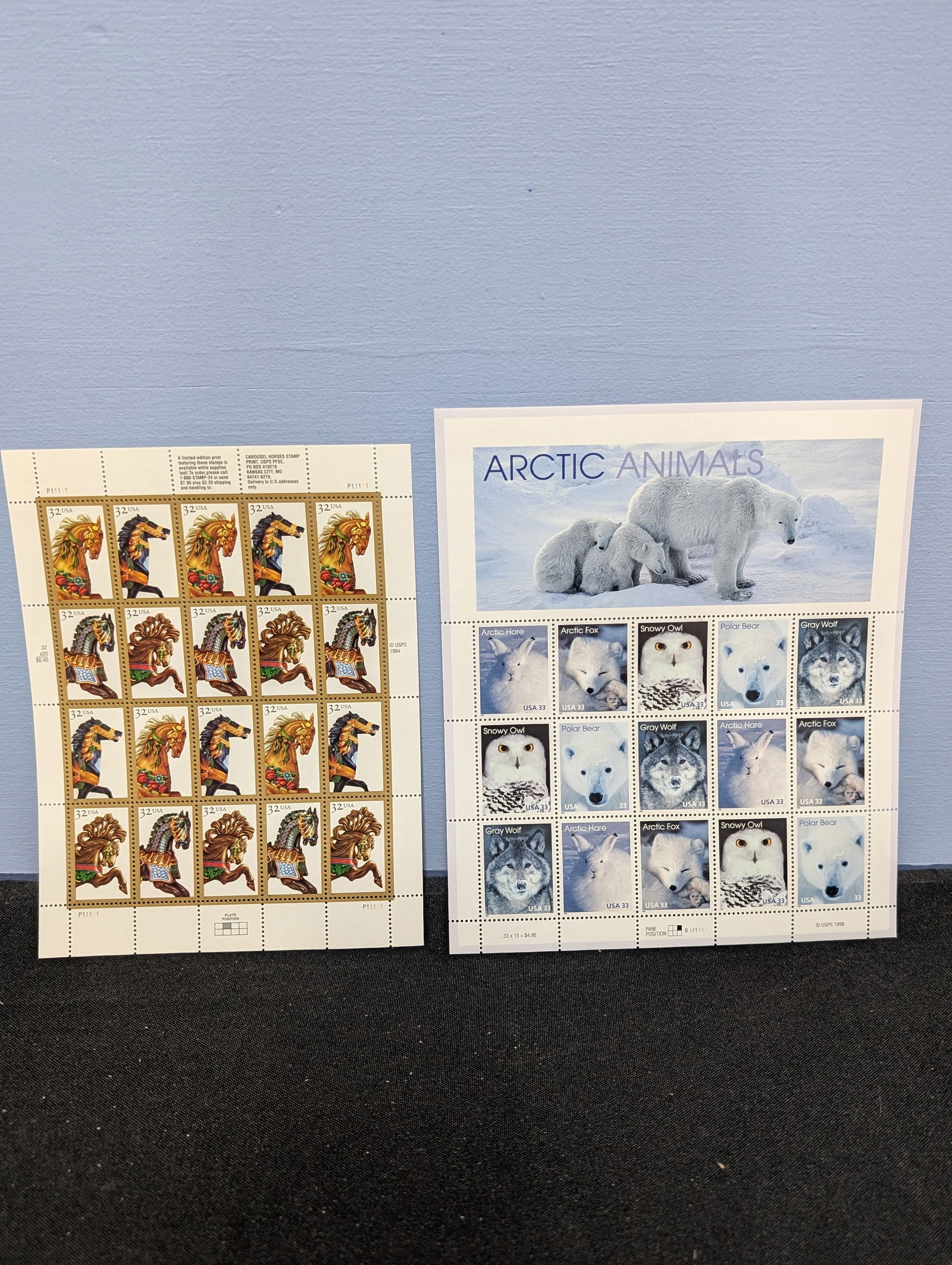 Two full sheets of unused US postage stamps featuring Carousel Horses and Arctic Animals. (1 of 3)