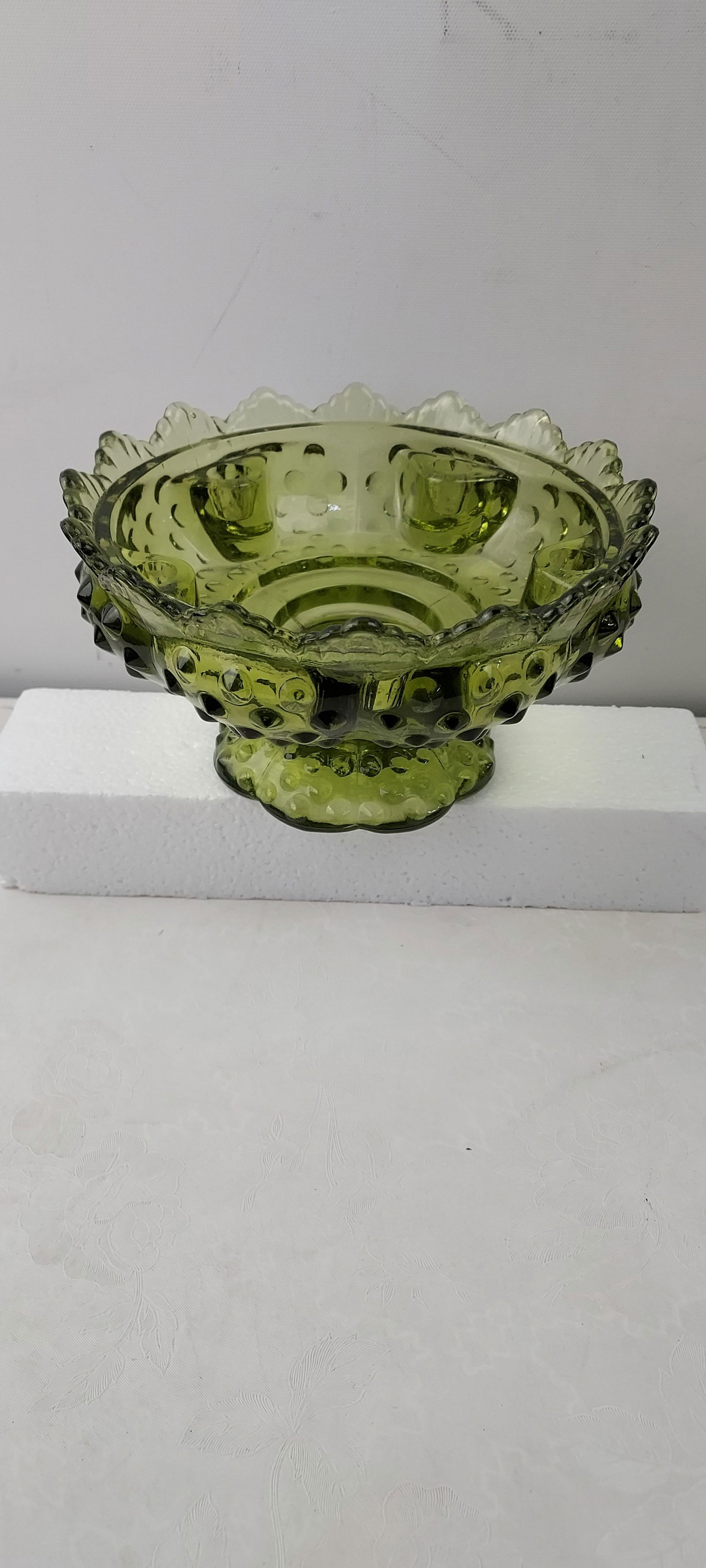 Vintage Fenton Colonial Green Hobnail Pedestal 6 Candle Holder: This elegant piece of Fenton art glass is identified as a Vintage Fenton Colonial Green Hobnail Pedestal 6 Candle Holder. It features a distinctive olive green hue, consistent with Fenton's 'Colonial