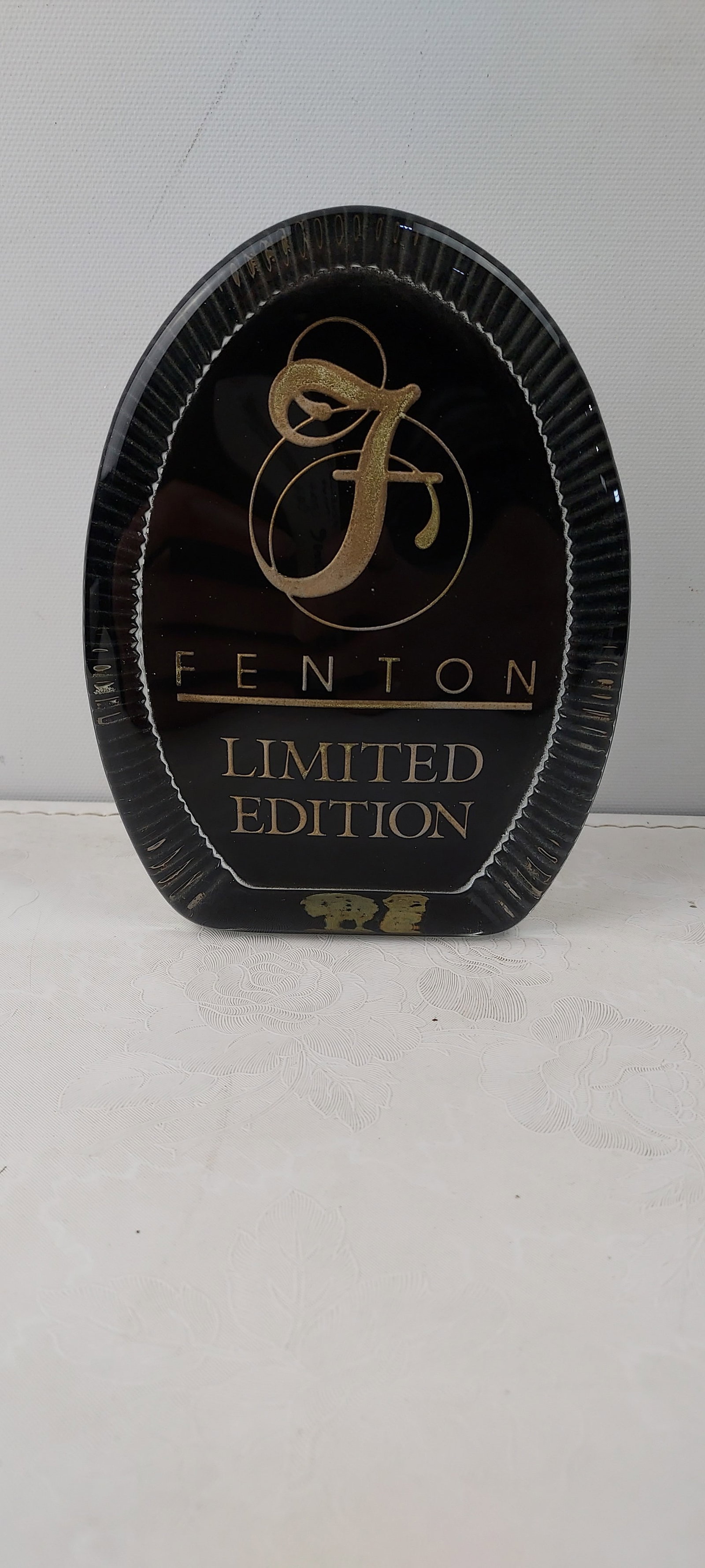 Fenton Art Glass Limited Edition Dealer Sign Paperweight: This is an authentic Fenton Art Glass Limited Edition Dealer Sign Paperweight. The oblong/oval-shaped piece features a central black panel adorned with the prominent "FENTON" name and a stylized 'F' l