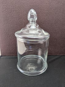 A Decorative Clear Glass Apothecary Jar with Domed Lid and Finial