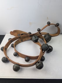 A Set of Antique Brass Petal Sleigh Bells on Leather Straps