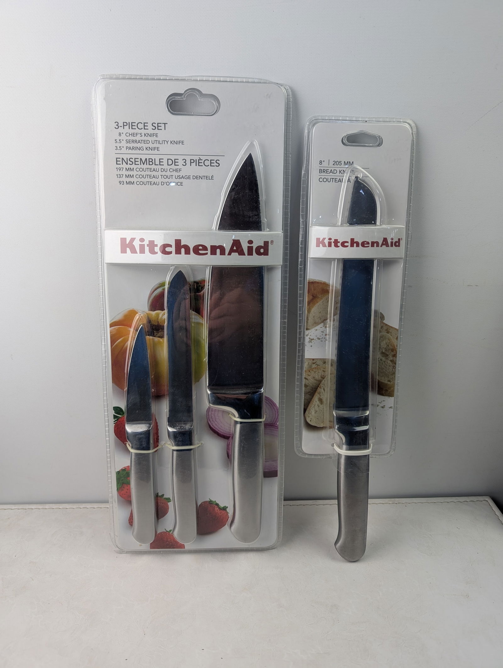 A Lot of Two KitchenAid Factory-Sealed Knife Sets: 3-Piece Chef/Utility/Paring (KKS53SSST) and 8" (1 of 5)