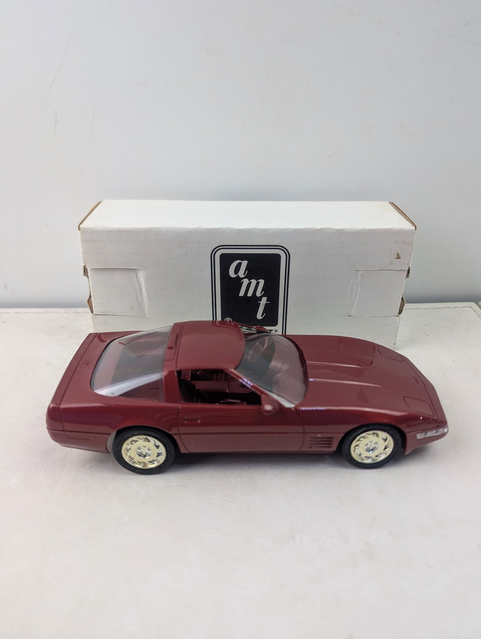 1991 AMT ERTL Chevrolet Corvette ZR-1 Dealer Promo Model Car #6034 (Medium Brilliant Red Metallic): A 1991 AMT ERTL Chevrolet Corvette ZR-1 Dealer Promo Model Car, model number 6034, presented in a "Medium Brilliant Red Metallic" finish. This 1/25 scale die-cast model features clear plastic windows