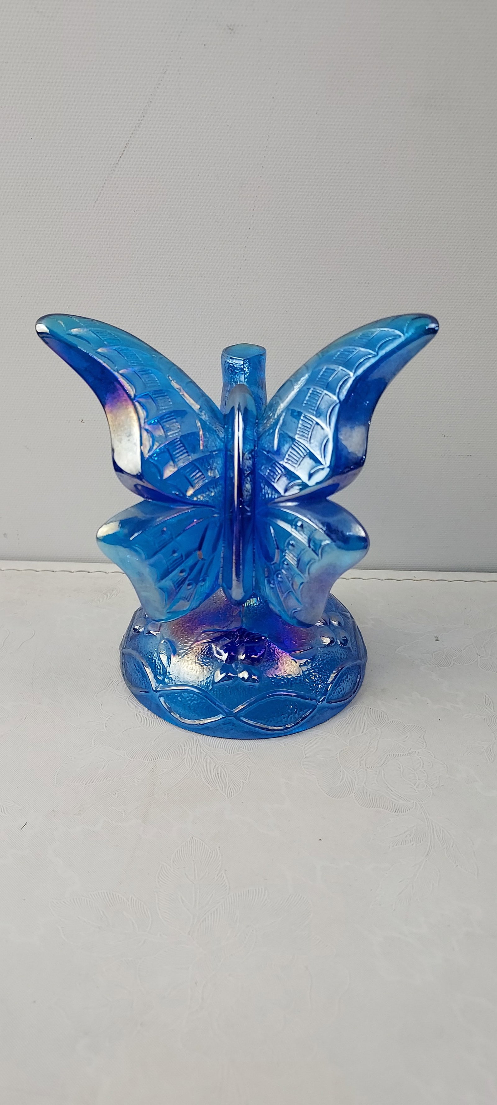 Fenton Art Glass Blue Iridescent Butterfly Ring Holder Figurine: This exquisite piece is identified as a Fenton Art Glass Blue Iridescent Butterfly Ring Holder Figurine. Sculpted from iridescent blue glass, the figurine depicts a butterfly with textured, veined win