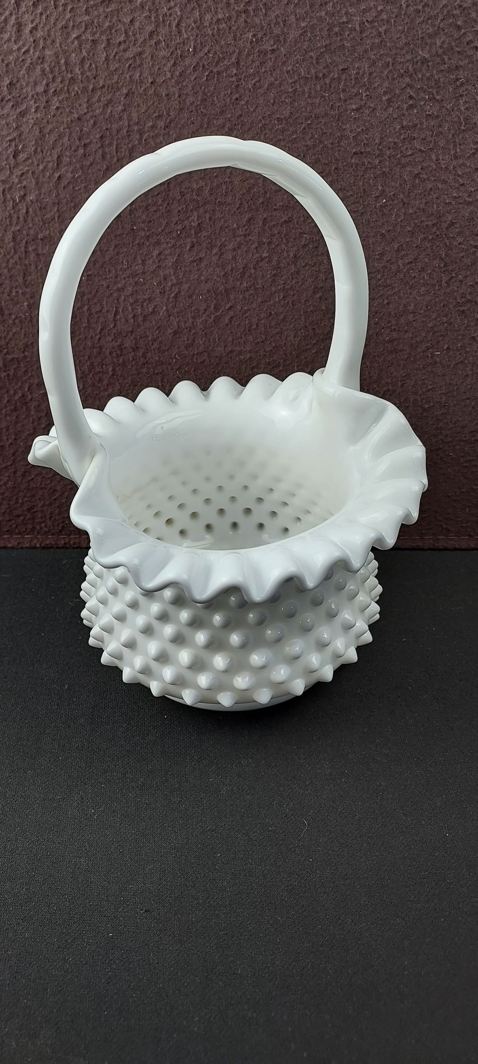 Fenton White Milk Glass Hobnail Basket with Applied Handle, #3632: This is a Fenton White Milk Glass Hobnail Basket with an applied handle, identified by the catalog number 3632. The decorative basket features a distinct hobnail pattern across its exterior body, a cr