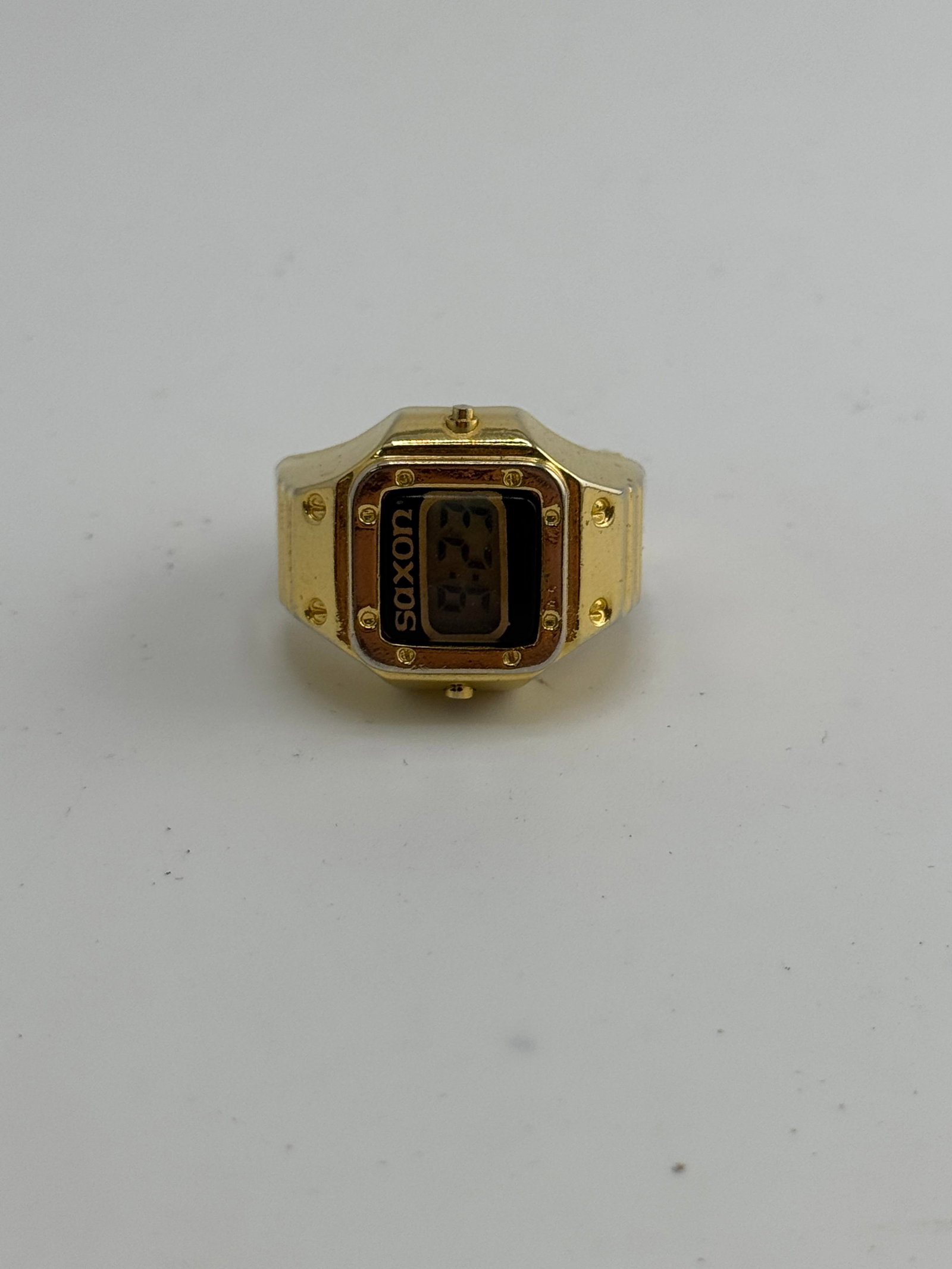 Saxon gold coloured ring watch: Saxon gold coloured ring watch, watch only, working at the time of catalogue The working order, accuracy or any implied water resistance of any lots sold is not guaranteed. For more information