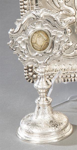 Reliquary in the form of a custody in silver, possibly: Rococo style with virile that shows both on the front and back, small relics with a placard with the name of the saint. Size: 23 x 9 cms.