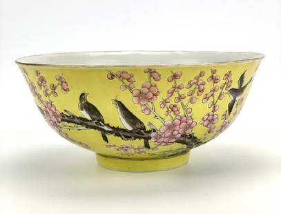 Chinese Yellow Famille Rose Bowl,19-20th C.: A Chinese porcelain Famille Rose bowl depicting magpies in a flowering plum tree against a yellow background, with a gold rim. 6 red iron Chinese character marks are seen on its underside. H: 2 7/8" (