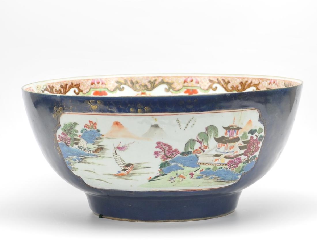 Large Blue Ground Famille Rose Bowl, 18-19th C.: A large blue Famille Rose Bowl from Daoguang Period with idealic riverside village scenes in windows of two sides and in the base of the bowl featuring: classic stone buildings with arched roofs, a pa