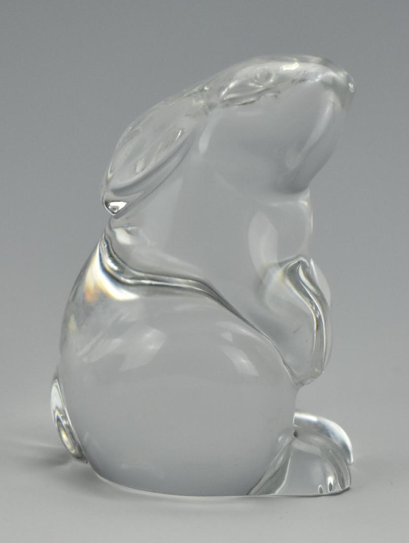 A Crystal Rabbit by Baccarat of France: A plump crystal rabbit by French crystal maker Baccarat (founded by royal decree of King Louis XV in 1764). It sits in a slightly raised pose with its head raised, its forepaws lifted, & its hind feet