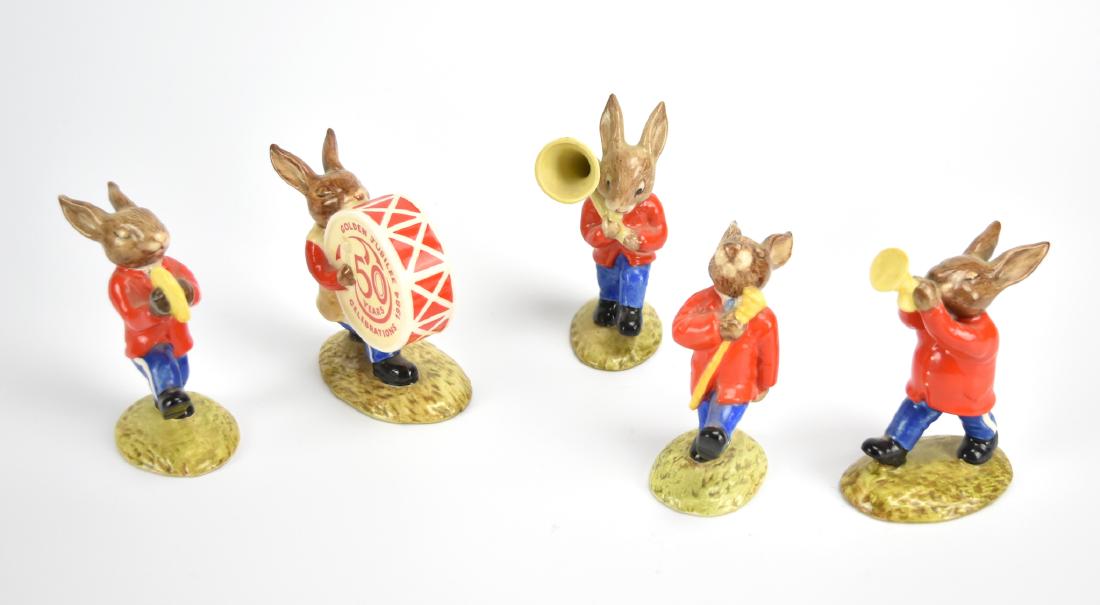 Royal Doulton Figurines: Rabbit Marching Band 5pc: A 5 piece set of Royal Doulton figurines depicting an all rabbit marching band in red jackets with striped blue slacks including: a drum major with staff, a trumpeter, a contra-tuba player, a cymbal p