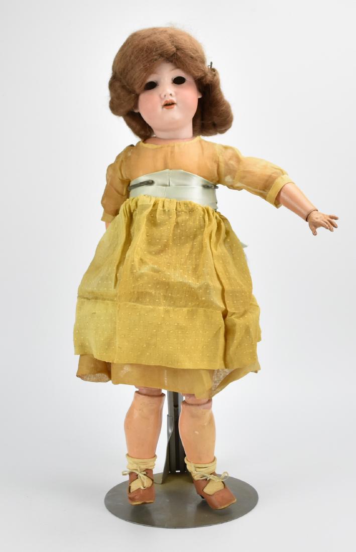 Armand Marseille Porcelain Doll w/ Stand , 1920: An Armand Marseille doll (signed and numbered) with fine auburn hair, a painted bisque head, and poseable 'ball-jointed' composition body with accompanying metal stand. H: 23" (58.3cm) Condition: Expe