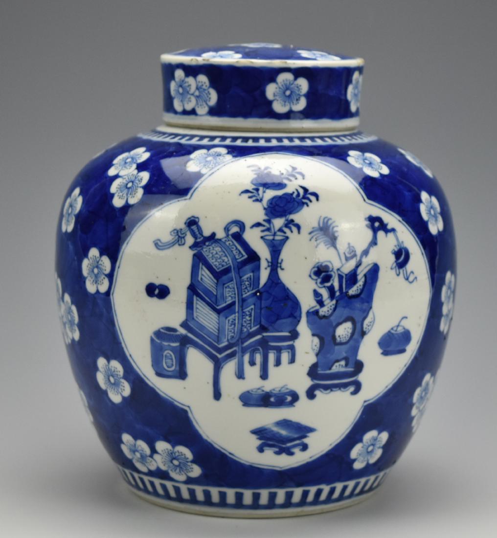 A Blue and White Jar and Cover,18-19th C.: of globular form, decorated with blossoming prunus branches on a crack-ice-pattern, Chinese antique pattern painted in two open window front and back H:8 1/4 in.(21 cm) Condition: in good condition wi