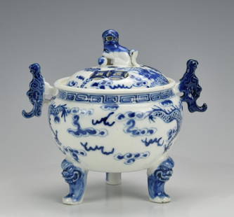 Chinese Blue and White Porcelain Censer,19th C.: A blue & white, Chinese, porcelain tripod censer of globular form with waisted shoulder, everted lip, lion mask cabriole legs, twin taotie-shaped sculpted side-handles, and foo-dog finial upon the dom