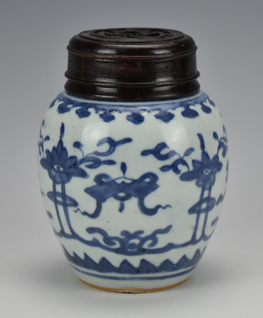 Blue and White Jar with wood Cover,17th C.: A Ming dynasty blue and white jar decorated with blue and white buddhist eight reasures ,double ring mark underside H:4 3/ in.(12 cm) Condition: in good condition with dense tiny pin-holes at the bott