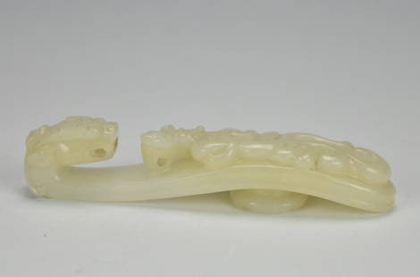 White Jade Belt Hook w/ Dragon,17/18th C.: A decorative white jade hook used to fasten robes closed, in the shape of a dragon looking down at a taotie. L: 3 3/4" (9.5cm) Condition: in excellent condition