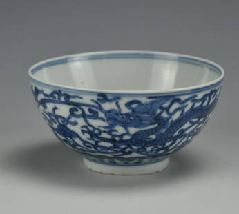 Chinese Blue and White Dragon Bowl w/ Wanli Mark: A small, blue & white, Chinese, porcelain bowl with a dragon amidst foliate scroll in the well, an unadorned white inner wall bordered by concentric blue rings, and a pair of dragons moving right to l