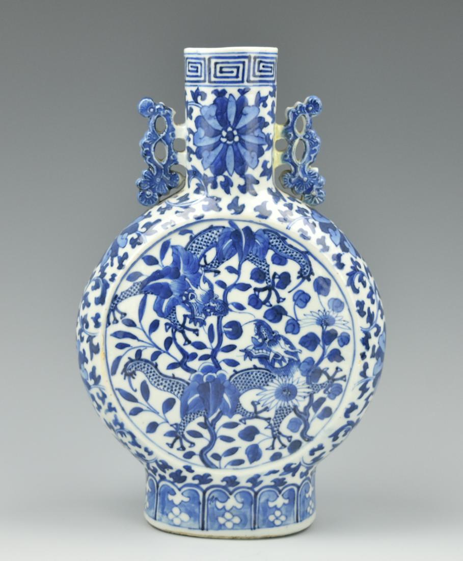 Chinese Blue & White Dragon Vase,GuangXu Period: A blue & white, Chinese, porcelain moon flask vase with a foot painted with a band of lapis, twin latticework handles on either side of the straight neck, with a decoration of a pair of dragon dancing