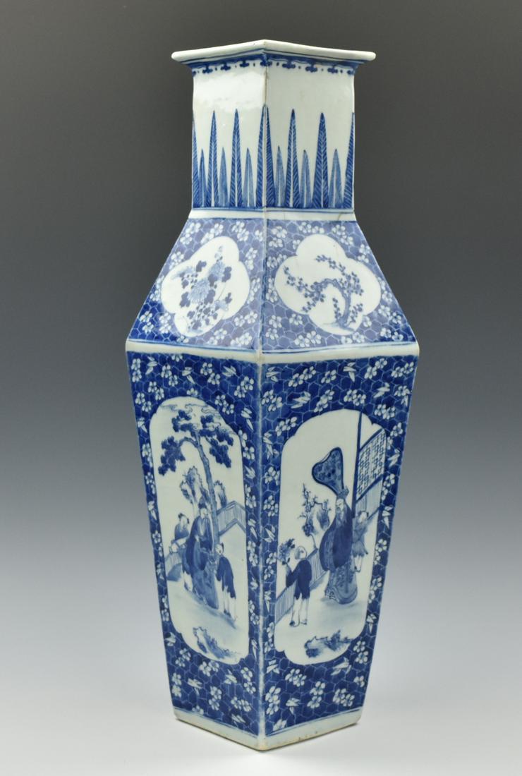 Chinese Blue & White Square Vase,19th C.: A Chinese, porcelain, square sided, wide shouldered, flared mouth, and straight neck vase decorated with ruyi scroll on the rim, pine trees on the neck, four paneled windows painted with four Chinese 